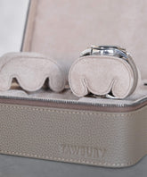The TAWBURY Fraser Watch Case Pillows - X-Small - Beige features two cushioned compartments with a beige leather exterior and interior. One holds a watch, while the other includes slender wrist pillows for protection. It perfectly combines elegance and practicality among watch travel cases.